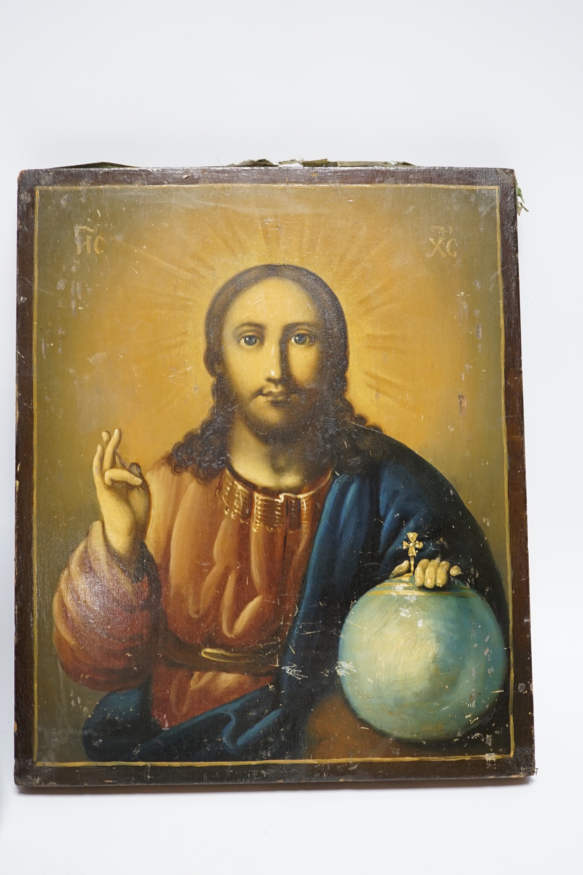 An early 20th century Russian Icon painted on wooden panel of Christ, with inscription and four seals reverse together with a later smaller Icon, largest 22.5cm wide x 27cm high